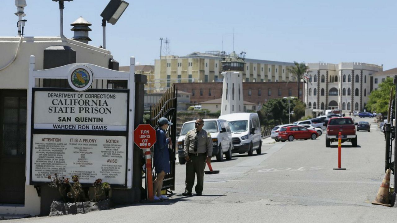 FILE - In this July 24, 2019, file photo, is the main entryway leading into San Quentin State Prison in San Quentin, Calif. Gov. Gavin Newsom is proposing to significantly shrink the footprint of California's juvenile and adult prison system, partly because of massive budget cuts prompted by the pandemic but also as a philosophy. (AP Photo/Eric Risberg, File)