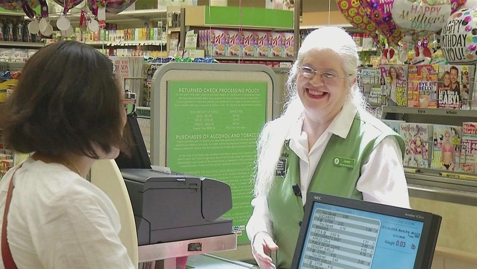 Joan Sardinas has been serving customers at Publix with a smile for 24 years--and it hasn't gone unnoticed. Her loyal customers helped her receive a free hearing aid after her's broke and couldn't afford a new one. (Spectrum Bay News 9 image)