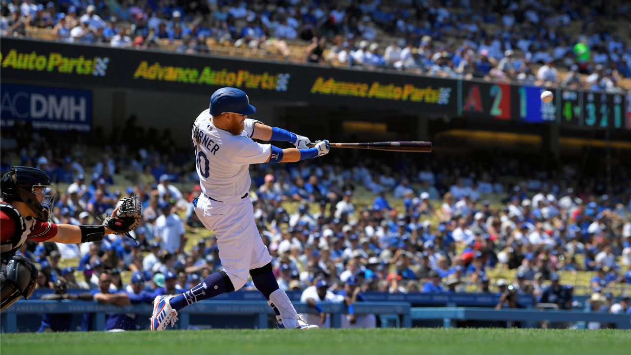 Los Angeles Dodgers' Justin Turner, right, hits a three-run home run as Arizona Diamondbacks catcher Daulton Varsho watches during the fourth inning of a baseball game Wednesday, May 18, 2022, in Los Angeles. (AP Photo/Mark J. Terrill)