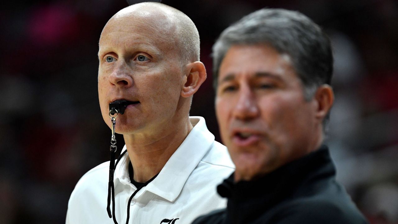 UofL men's basketball head coach Chris Mack (left) stands beside former assistant coach Dino Gaudio. (AP Photo)