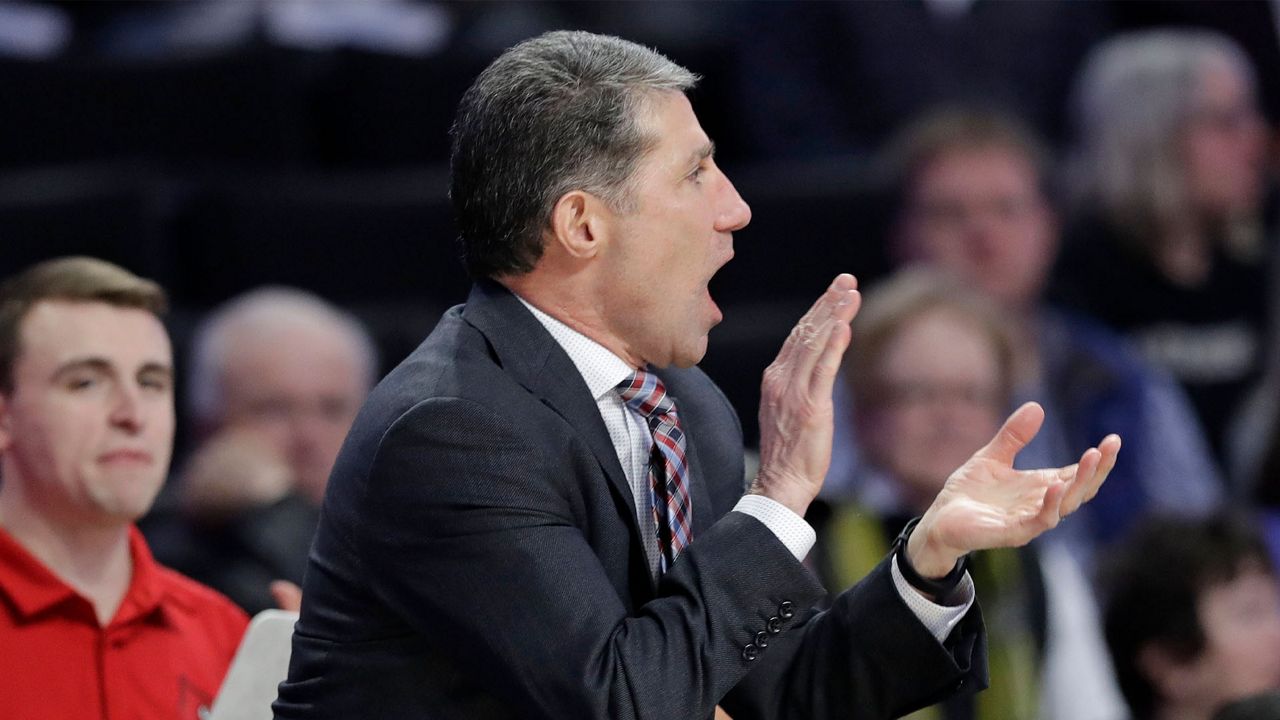 Louisville assistant coach Dino Gaudio cheers on his team against Wake Forest during the second half of an NCAA college basketball game in Winston-Salem, N.C., Wednesday, Jan. 30, 2019. (AP Photo/Chuck Burton)