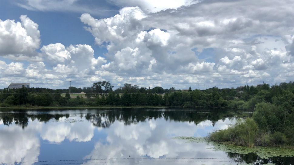 Clouds build over Big Sand Lake in the Dr. Phillips area of Orlando on Friday afternoon, May 18, 2018.