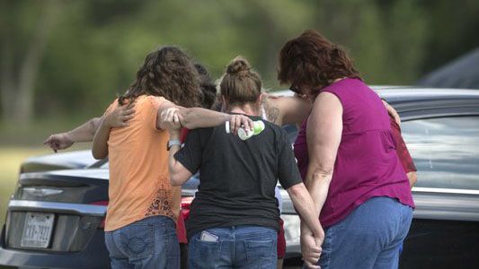 Parents of Santa Fe High School students join in prayer at the parking lot of the Arcadia First Baptist Christian School accompanied by residents after a shooter open fired at the high school, Friday, May 18, 2018, in Santa Fe, Texas. (Marie D. De Jesus/Houston Chronicle via AP)