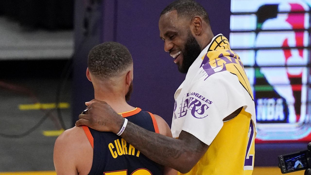 Los Angeles Lakers forward LeBron James, right, greets Golden State Warriors guard Stephen Curry after the Lakers defeated the Golden State Warriors 103-100 in an NBA basketball Western Conference play-in game Wednesday, May 19, 2021, in Los Angeles. (AP Photo/Mark J. Terrill)