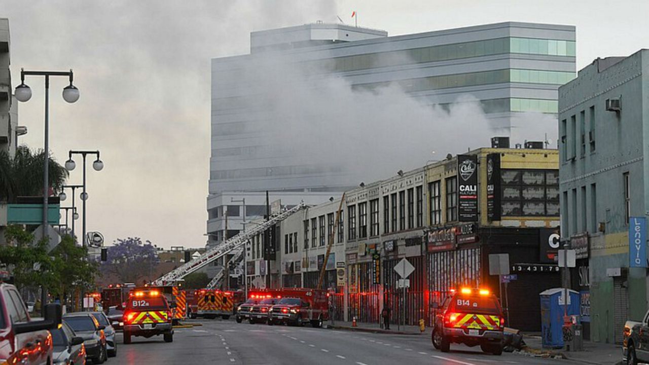 Los Angeles Fire Department firefighters work the scene of a structure fire that injured multiple firefighters, according to a fire department spokesman, Saturday, May 16, 2020, in Los Angeles. (AP Photo/Mark J. Terrill)