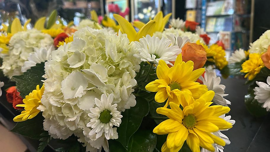 Arrangements of flowers sit on the counter at Janie Beane Florist in Clearwater as they await pickup. (Spectrum Bay News 9/Angie Angers)