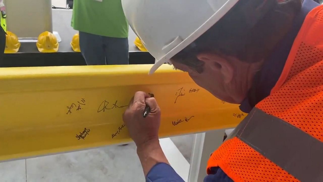 The event Wednesday at Brightline's partially completed vehicle maintenance facility near Orlando International Airport included company officials, politicians and dozens of workers in hard hats. (Spectrum News/Pete Reinwald)