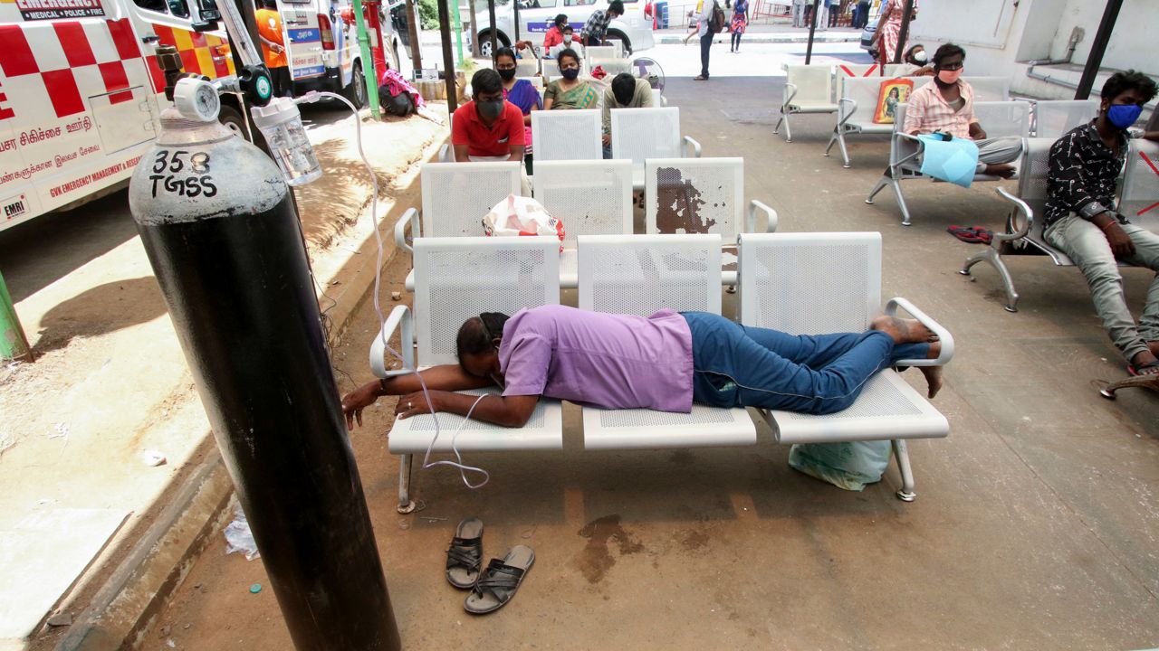 In this photo from Monday, May 17, 2021, a COVID-19 patient on oxygen support waiting for admission to a hospital rests on chairs outside the Tamil Nadu Government Multi Super Speciality Hospital in Chennai, India. (AP Photo/R. Parthibhan)