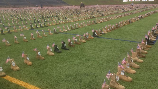 Over 7,000 boots cover the field at Fort Bragg's Hedrick Stadium. Each boot represents a fallen soldier who has died since 9-11.
