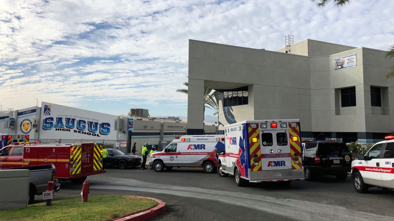 Ambulances are parked outside of Saugus High School after reports of a shooting on Thursday, Nov. 14, 2019 in Santa Clarita, Calif. (AP Photo/Marcio Jose Sanchez)