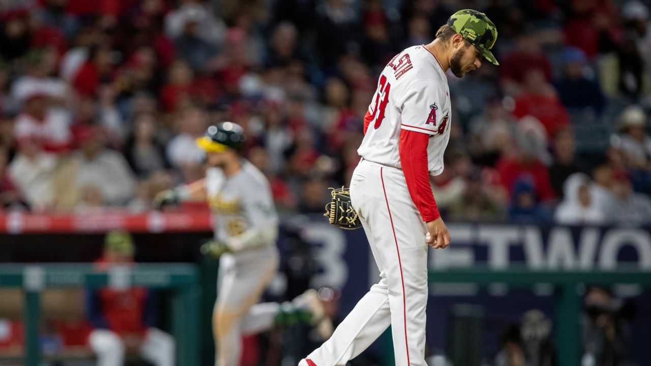 Los Angeles Angels starting pitcher Chase Silseth, right, looks away as Oakland Athletics' Seth Brown rounds third after hitting a two-RBI home run during the fifth inning of a baseball game in Anaheim, Calif., Friday, May 20, 2022. (AP Photo/Alex Gallardo)