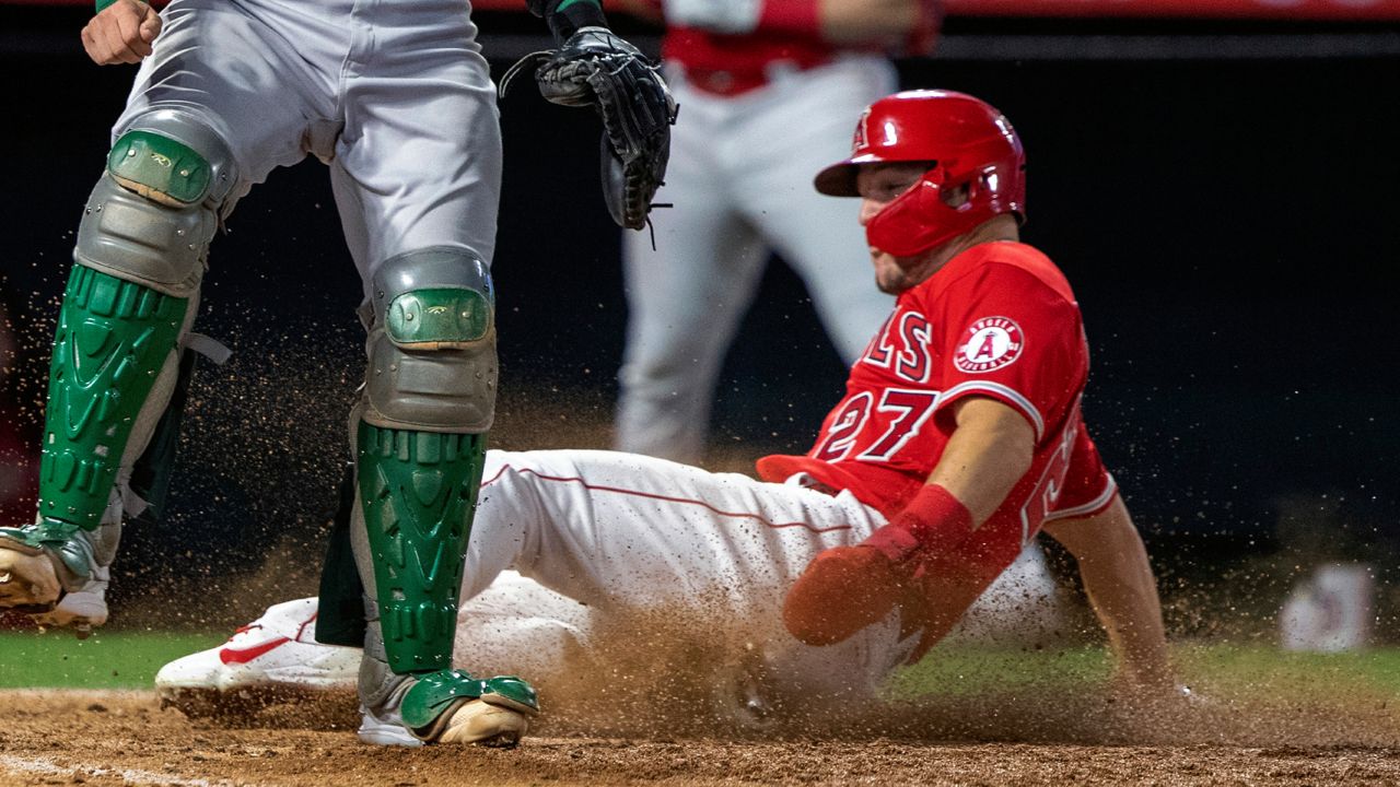 Los Angeles Angels' Mike Trout scores without a throw on an infield hit by Luis Rengifo during the sixth inning of a baseball game in Anaheim, Calif., Saturday, May 21, 2022. (AP Photo/Alex Gallardo)