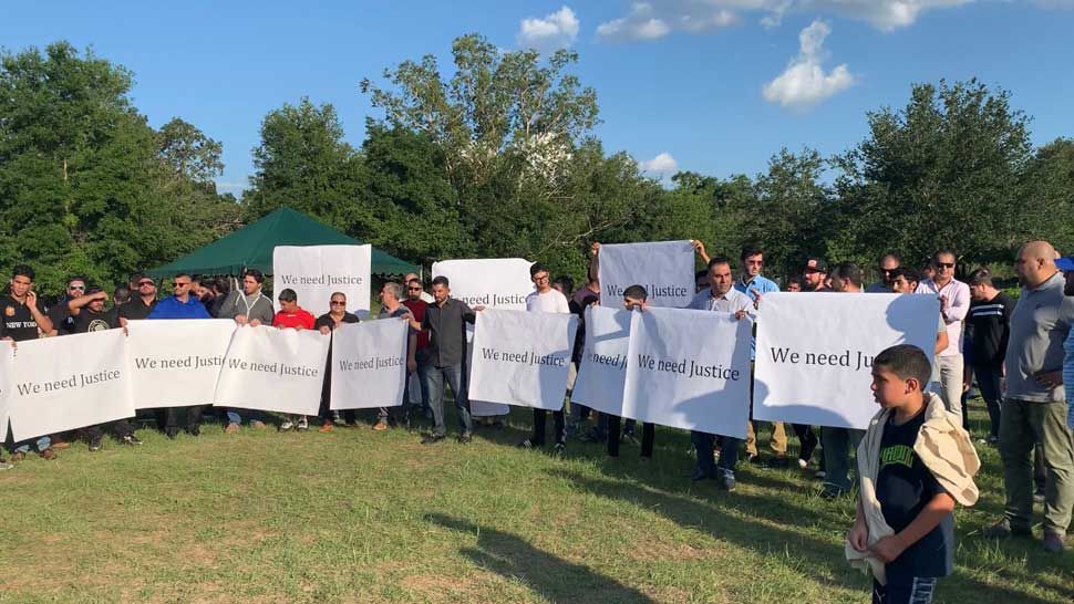 Protesters hold signs reading "We Need Justice" following the funeral of Rafat Saeed, who was shot and killed outside a Tampa mosque on Monday, May 20, 2019. No arrests have been made yet in the case. (Saundra Weathers/Spectrum Bay News 9)