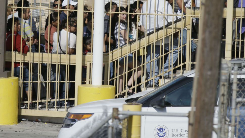 Pedestrians wait in line to enter the U.S. from Mexico in Laredo, Texas, across the Rio Grande from Nuevo Laredo, Tamaulipas, Thursday, July 23, 2015. (AP Photo/LM Otero)
