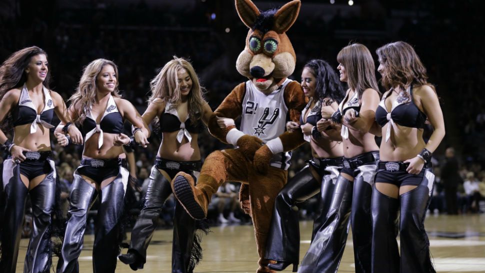 San Antonio Spurs coyote, center, and the San Antonio Spurs Silver Dancers perform during a timeout in the second half of an NBA basketball game against the Miami Heat, Friday, Feb. 6, 2015, in San Antonio. (AP Photo/Eric Gay)