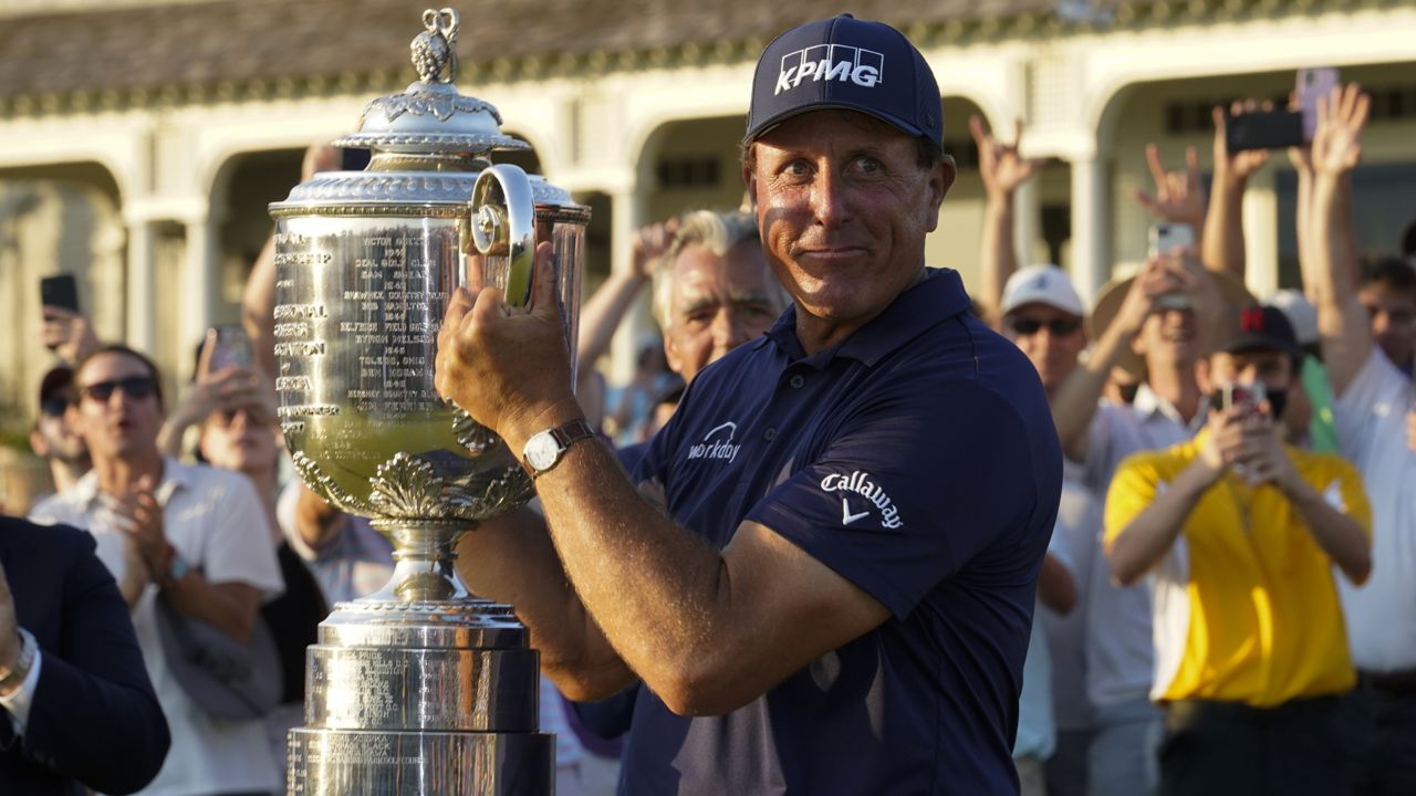 Phil Mickelson holds the Wanamaker Trophy after winning the final round at the PGA Championship golf tournament on the Ocean Course, Sunday, May 23, 2021, in Kiawah Island, S.C. (AP Photo/Matt York)
