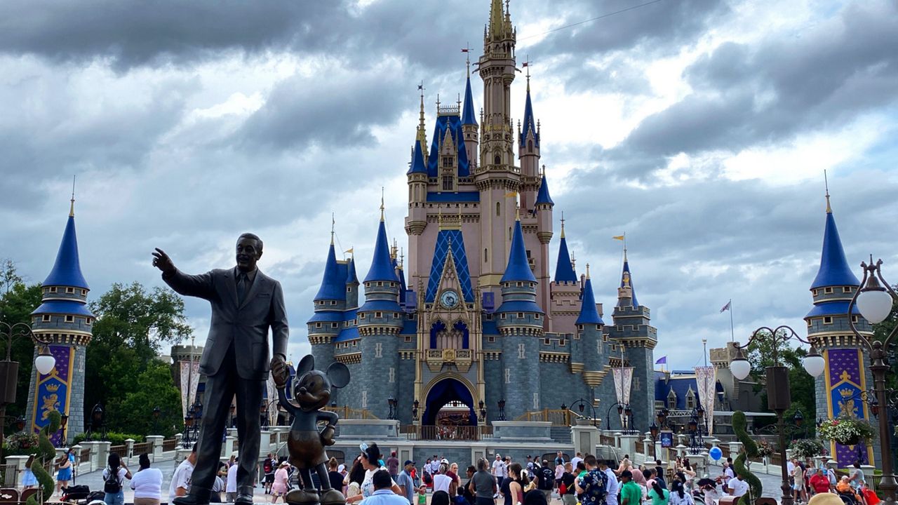 Statue of Walt Disney and Mickey Mouse with Cinderella Castle in the background at Magic Kingdom. (Spectrum News/Ashley Carter)