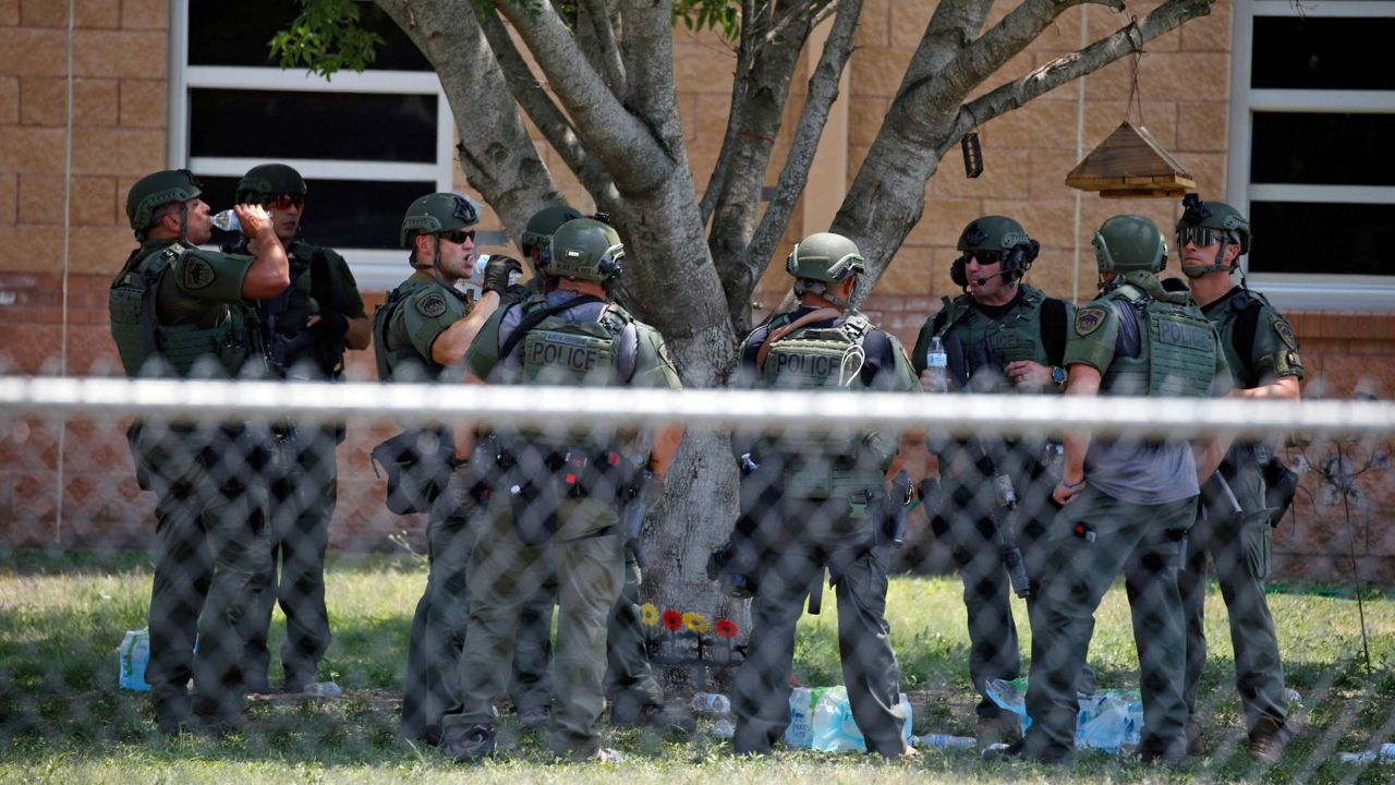 Law enforcement personnel stand outside Robb Elementary School following a shooting Tuesday in Uvalde, Texas. (AP Photo/Dario Lopez-Mills)