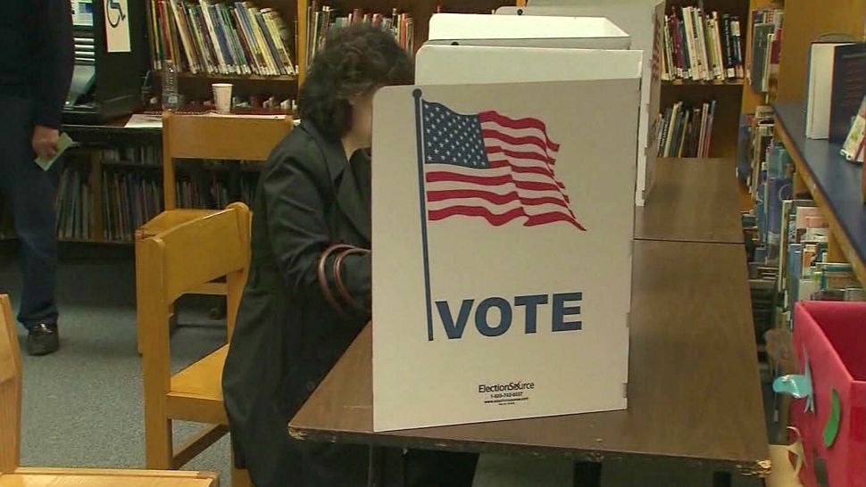 Photograph of a person at a voting booth (Spectrum News file image)