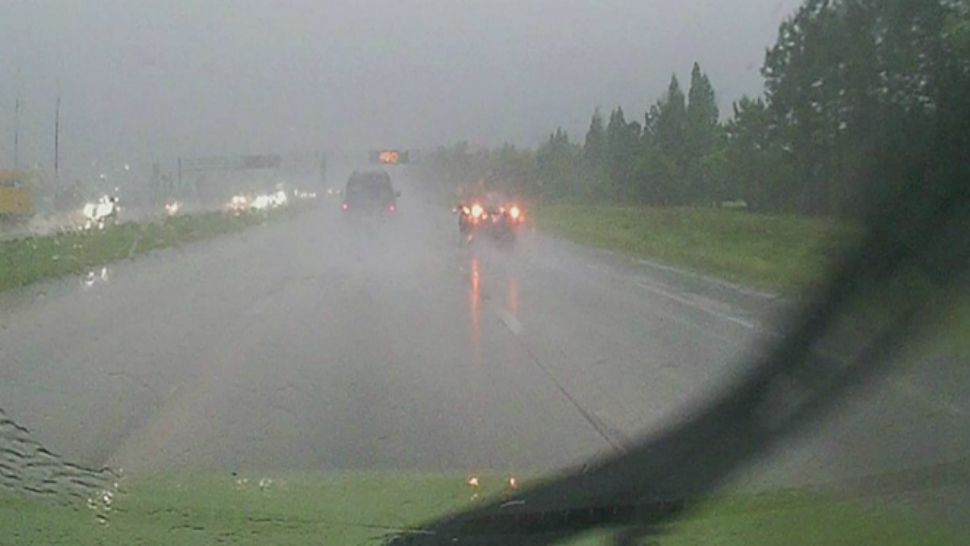 Although it might seem like a good idea to turn on your emergency lights while driving in heavy rain, don't do it. It's illegal — and it's dangerous. (File photo)