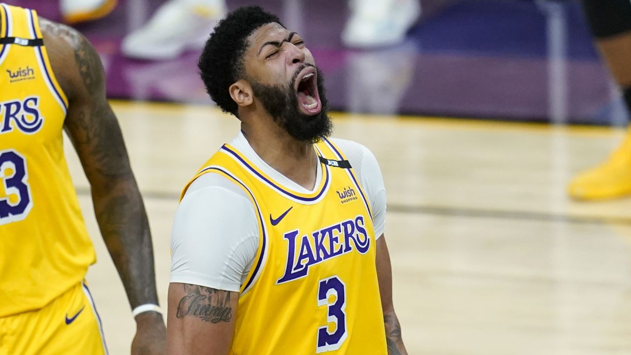 Los Angeles Lakers forward Anthony Davis shouts as he celebrates a stop against the Phoenix Suns during the second half of Game 2 of an NBA basketball first-round playoff series Tuesday, May 25, 2021, in Phoenix. (AP Photo/Ross D. Franklin)