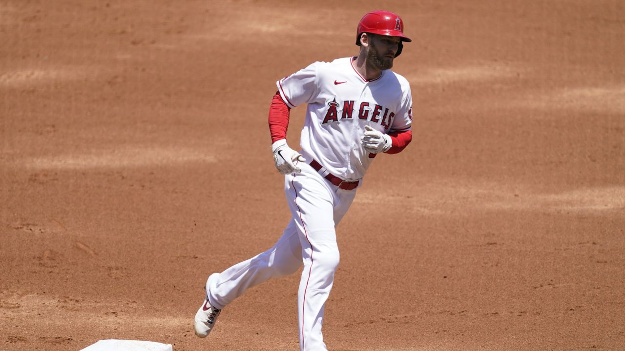 Los Angeles Angels' Taylor Ward (3) runs the bases after hitting a home run during the first inning of a baseball game against the Texas Rangers Wednesday, May 26, 2021, in Anaheim, Calif. Juan Lagares and Jose Rojas also scored. (AP Photo/Ashley Landis)