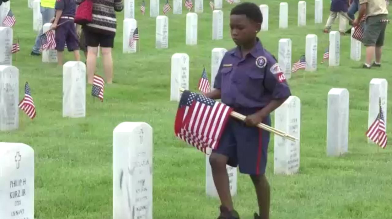 Marlborough scouts place flags on veterans' graves