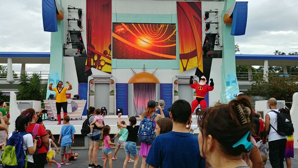 Guests at Magic Kingdom dance along with Mr. Incredible at the Tomorrowland Expo. (Ashley Carter, staff)