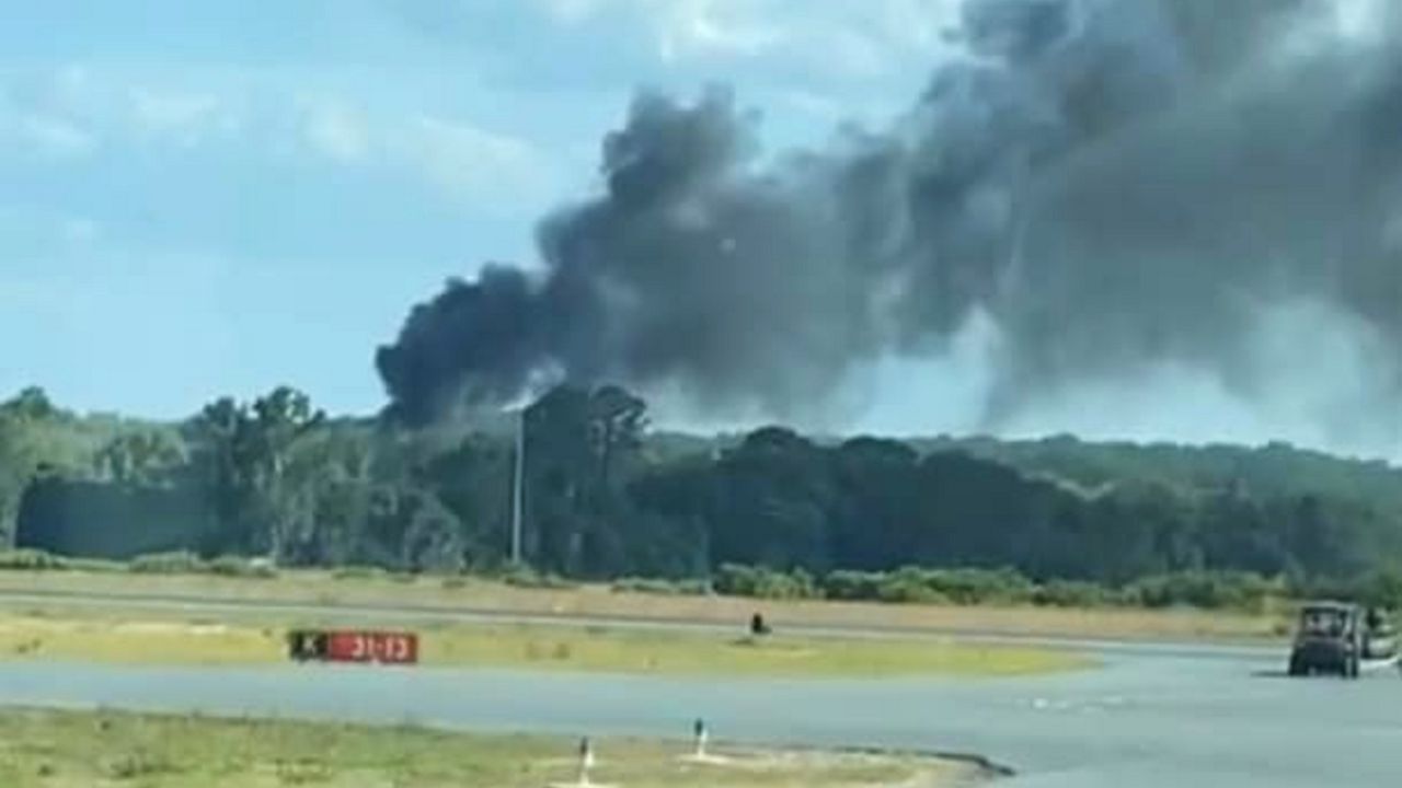 A smoke plume rises near Leesburg International Airport on May 25 after a firefighting helicopter on a training exercise crashed in a swamp. (Courtesy of Leesburg Fire Rescue)