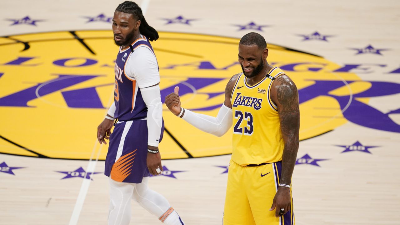 Los Angeles Lakers forward LeBron James (23) talks with Phoenix Suns' Jae Crowder during the second half in Game 3 of an NBA basketball first-round playoff series Thursday, May 27, 2021, in Los Angeles. (AP Photo/Marcio Jose Sanchez)