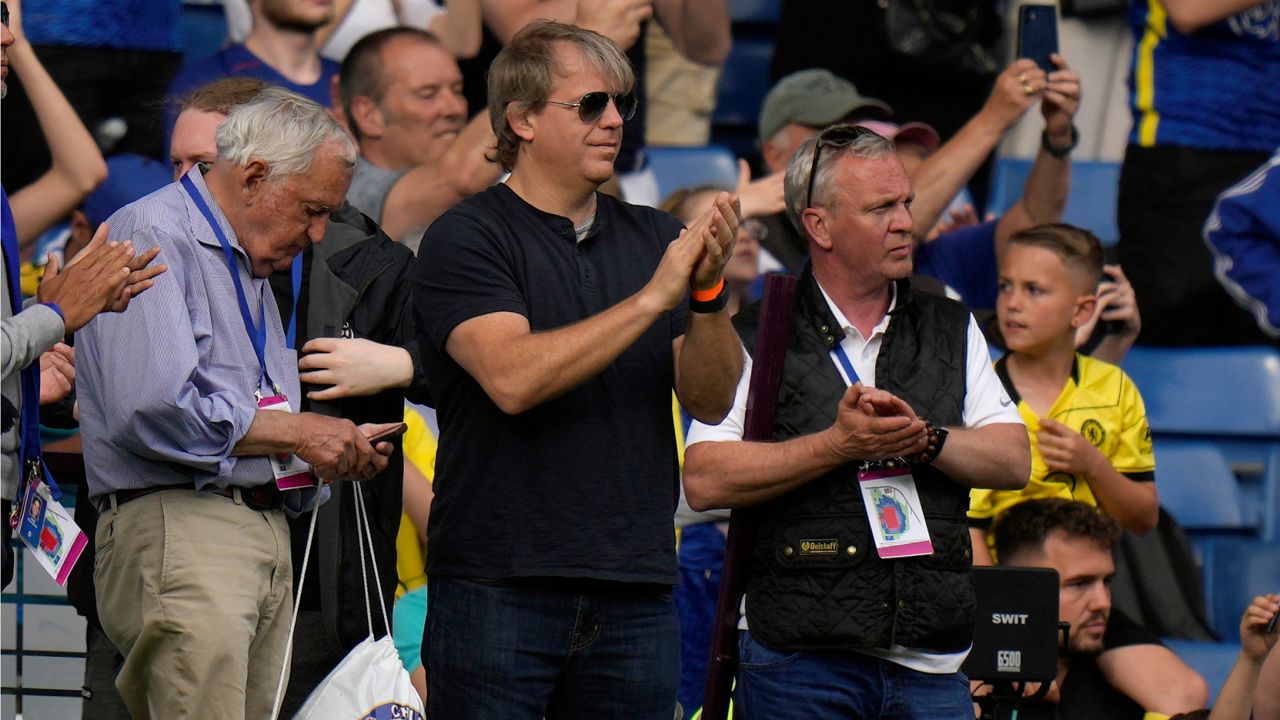 American businessman Todd Boehly, center, applauds as he attends the English Premier League soccer match between Chelsea and Watford at Stamford Bridge stadium in London, Sunday, May 22, 2022. (AP Photo/Alastair Grant)