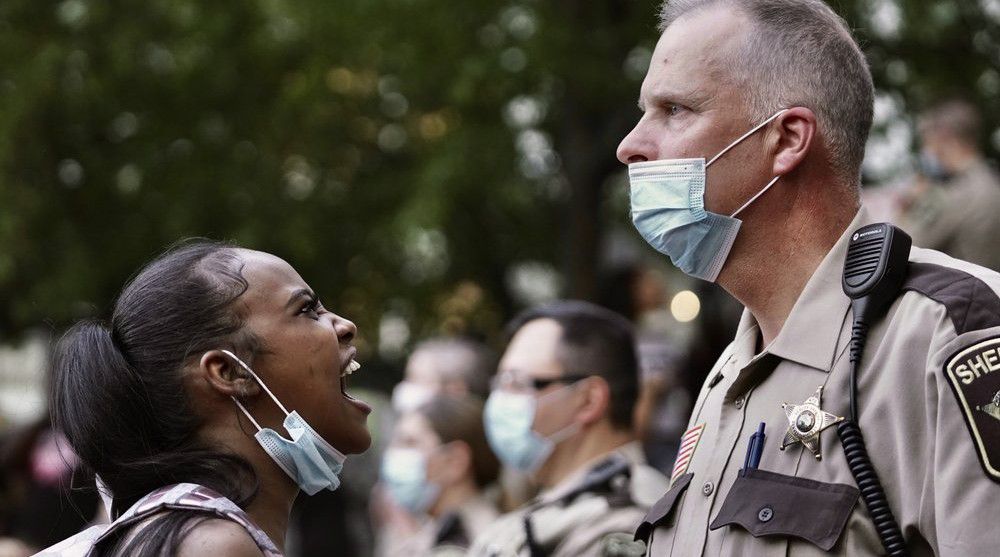 A woman yells at a sheriff's deputy during a protest following the death of George Floyd at the hand of Minneapolis police officers, Thursday, May 28, 2020, in Minneapolis. (Mark Vancleave/Star Tribune via AP)