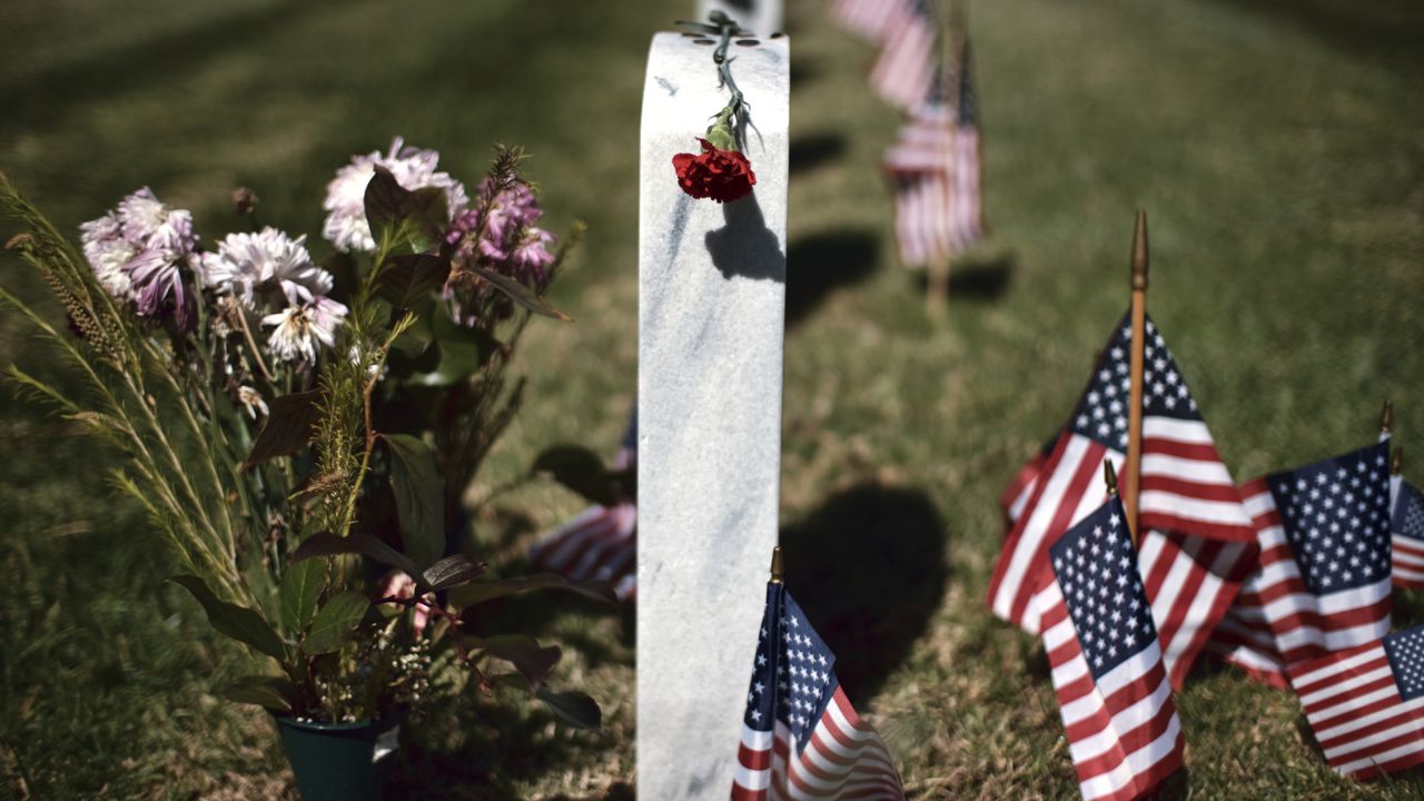 A rose is placed on a veterans grave during the Memorial Day celebrations at the Veterans National Cemetery in Los Angeles on Monday, May 27, 2019. (AP Photo/Richard Vogel)
