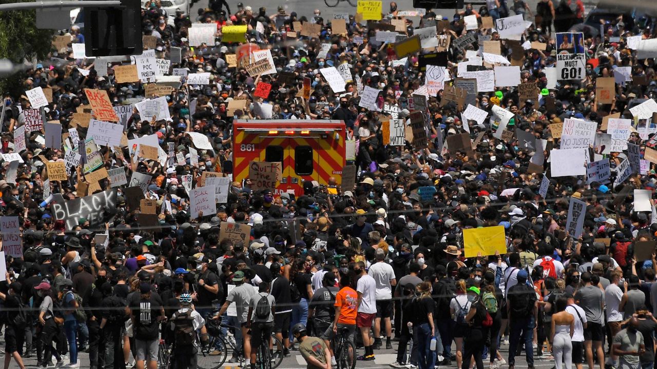 Demonstrators block the street as a Los Angeles Fire Department ambulance tries to get through during a protest over the death of George Floyd, May 30, 2020, in LA. (AP Photo/Mark J. Terrill)