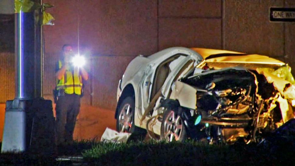 Four people were in the Cadillac when it struck a barrier under the State Road 436 overpass early Tuesday. The rear passengers were quickly removed, but the driver and front passenger were in critical condition, Casselberry Police said. (Ken Ashlin/Spectrum News 13)