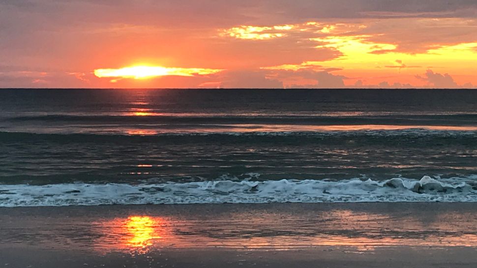 An Orlando surfer who went under was noticed by an off-duty Volusia County lifeguard and pulled the man to shore and started CPR at New Smyrna Beach on Sunday. (File photo of New Smyrna Beach.)