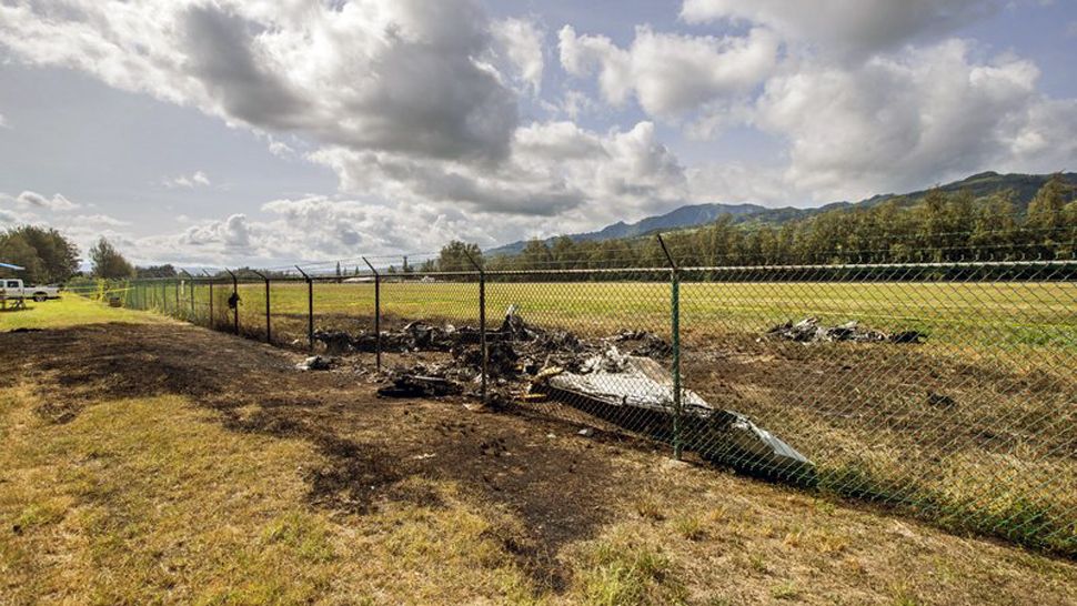 This is the site where a Beechcraft King Air twin-engine plane crashed Friday evening killing multiple people seen on Saturday, in Mokuleia, Hawaii. No one aboard survived the skydiving plane crash, which left a small pile of smoky wreckage near the chain link fence surrounding Dillingham Airfield, a one-runway seaside airfield. (AP)