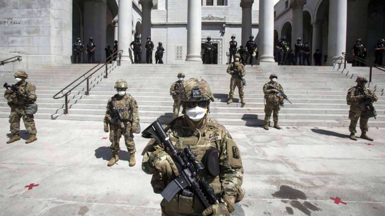 Members of the California National Guard stand guard outside the City Hall, Sunday, May 31, 2020, in Los Angeles. The National Guard is patrolling Los Angeles as the city begins cleaning up following a night of violent protests against police brutality. The demonstration Saturday night was sparked by the death of George Floyd, a black man who was killed in police custody in Minneapolis on May 25. (AP Photo/Ringo H.W. Chiu)
