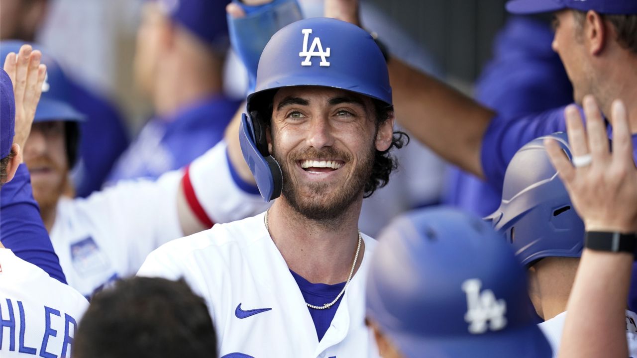 Los Angeles Dodgers' Cody Bellinger, center, smiles in the dugout after his grand slam against the St. Louis Cardinals during the first inning of a baseball game Wednesday, June 2, 2021, in Los Angeles. (AP Photo/Marcio Jose Sanchez)