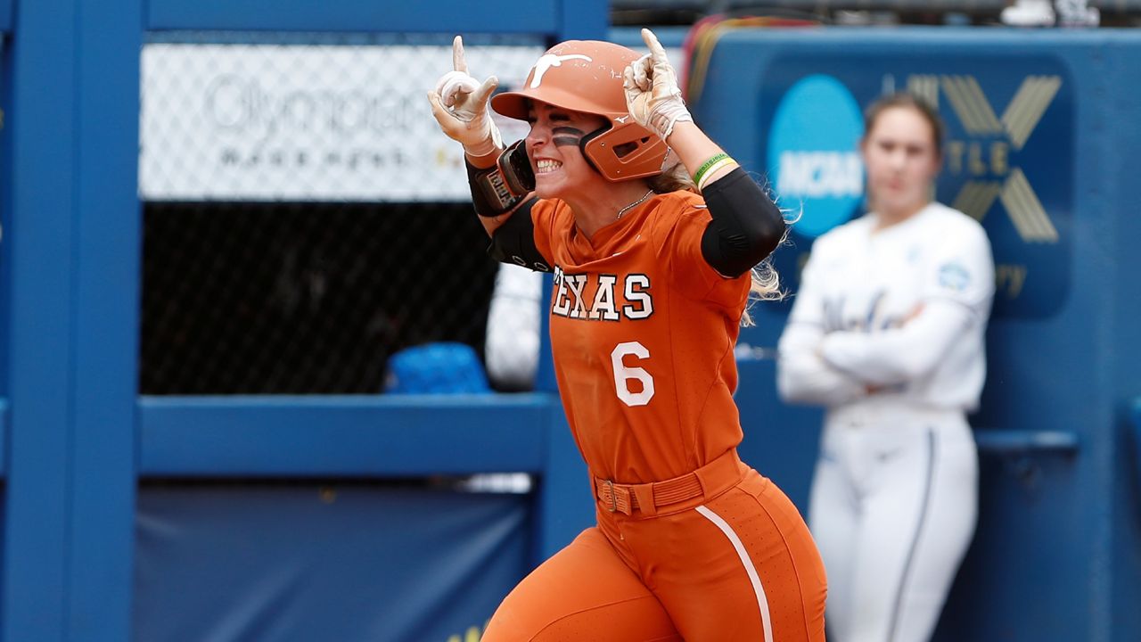 Texas outfielder Isabella Dayton (6) celebrates after a home run in the sixth inning of an NCAA softball Women's College World Series game against UCLA on Thursday, June 2, 2022, in Oklahoma City. (AP Photo/Alonzo Adams)