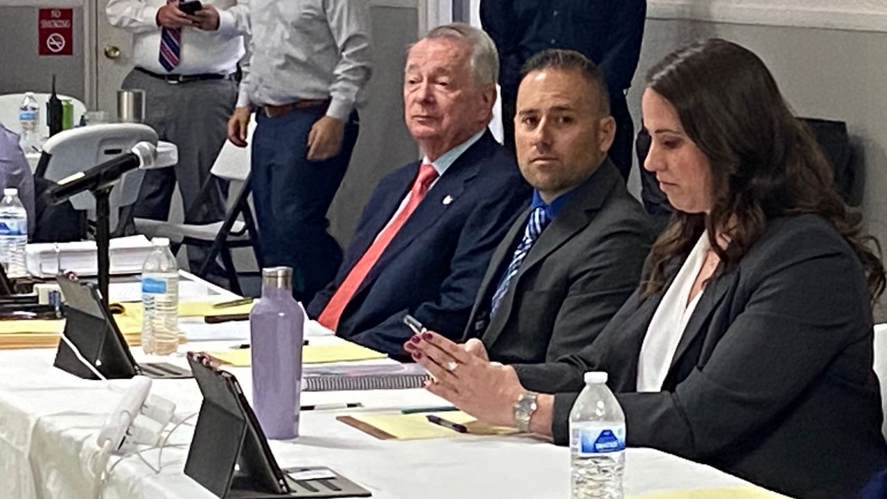 Former LMPD detective Joshua Jaynes (center) appeared before the Louisville Metro Police Merit Board in a hearing appealing his termination earlier this summer. (Spectrum News 1/Erin Kelly)