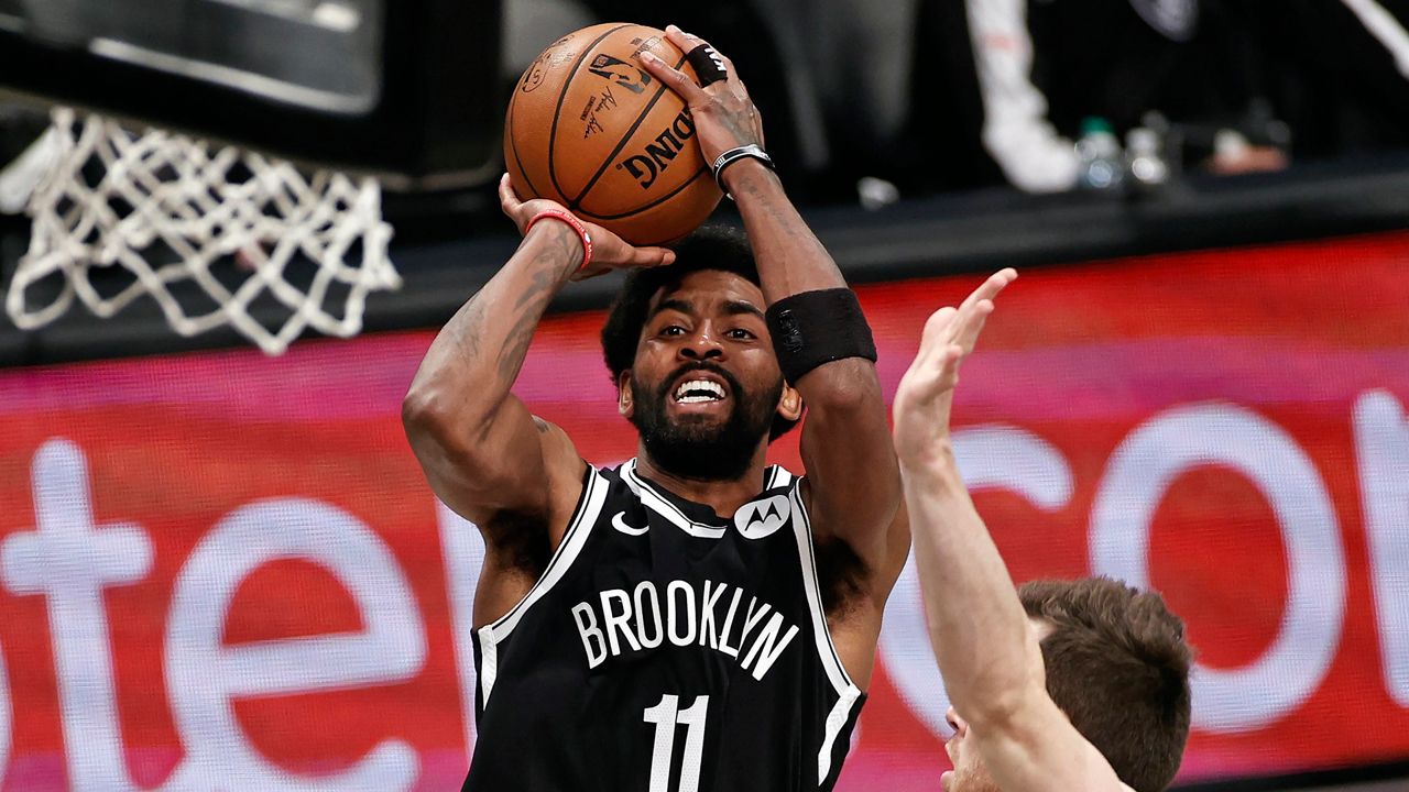 A June 5, 2021, file photo of Brooklyn Nets guard Kyrie Irving shooting against the Milwaukee Bucks during the second half of Game 1 of an NBA basketball second-round playoff series at the Barclays Center in Brooklyn