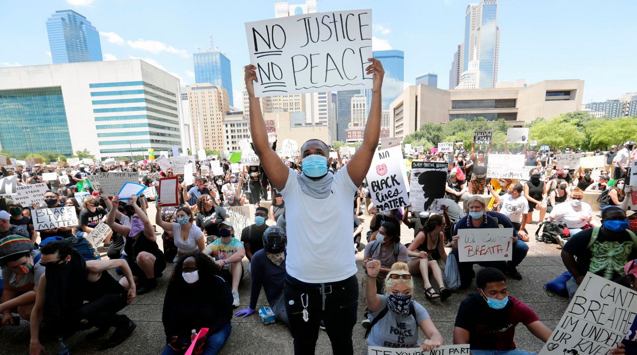 Protesters demonstrate police brutality in front of Dallas City Hall in downtown Dallas, Saturday, May 30, 2020. Protests across the country have escalated over the death of George Floyd who died after being restrained by Minneapolis police officers on Memorial Day. (AP Photo/LM Otero)