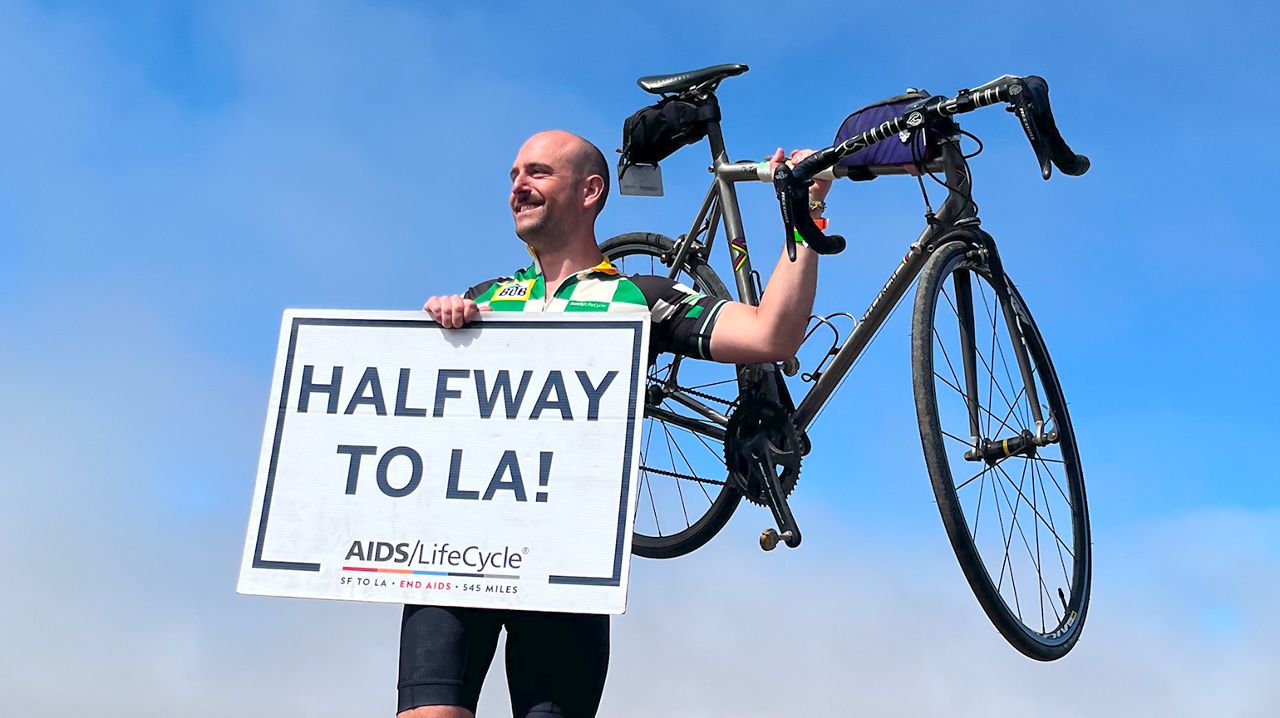 AIDS/LifeCycle participant Alex Marchinski holding his bike. 