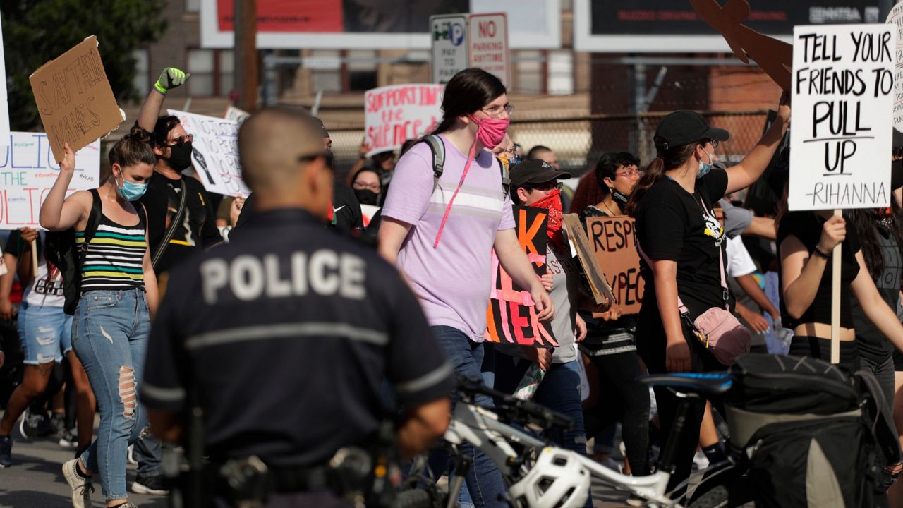 Protesters march in San Antonio, Wednesday, June 3, 2020, over the death of George Floyd, an African American who died on May 25 after a white Minneapolis police officer pressed a knee into his neck for several minutes even after he stopped moving and pleading for air. (AP Photo/Eric Gay)