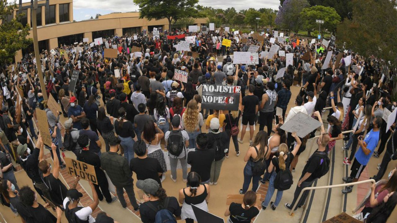 Demonstrators gather at the Simi Valley civic center during a protest, Saturday, June 6, 2020, in Simi Valley, Calif. over the death of George Floyd. Protests continue throughout the country over the death of Floyd, a black man who died after being restrained by Minneapolis police officers on May 25. (AP Photo/Mark J. Terrill)