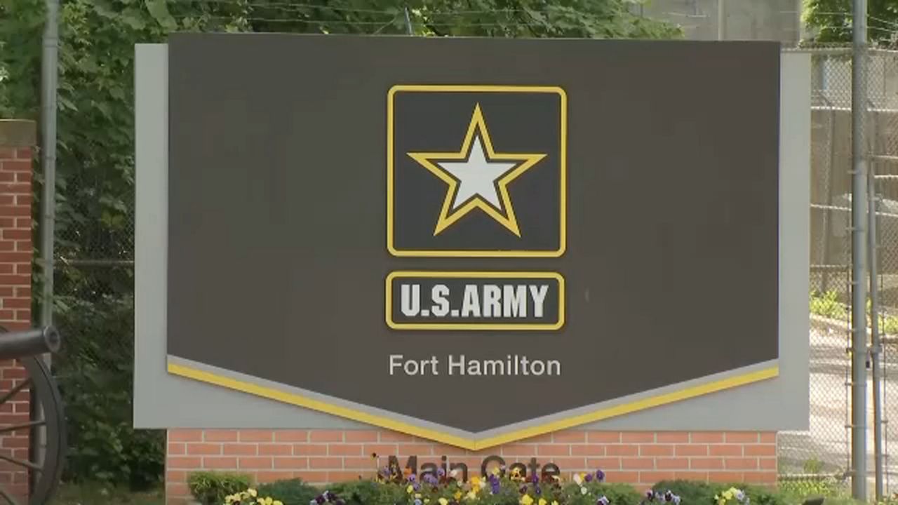 The Fort Hamilton U.S. Army logo against a brown background.