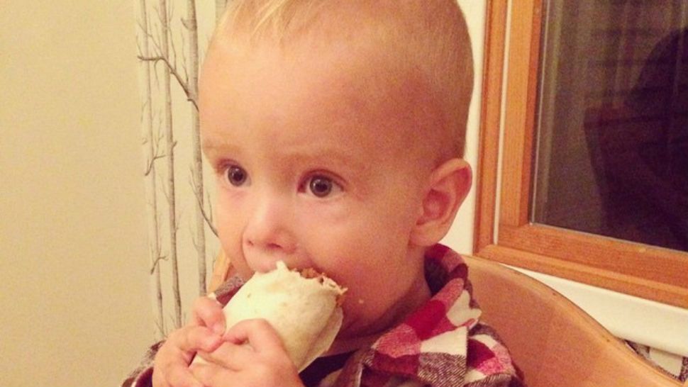FILE- Baby eats taco.