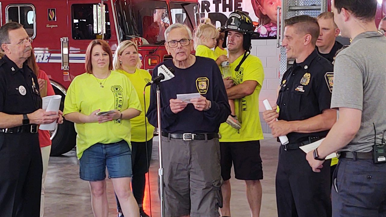 Former WHAS Crusade for Children director Bud Harbsmeier presents with Highview Fire Department at the 68th annual WHAS Crusade for Children on June 6, 2021. (WHAS-TV/Phil Dunaway)