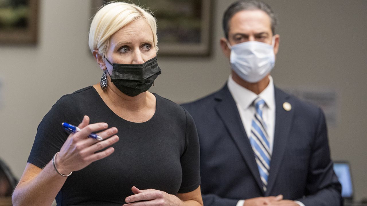 Senior Deputy District Attorney Whitney Bokosky, left, speaks as Orange County District Attorney Todd Spitzer listens in at the arraignment and bail hearing for Marcus Anthony Eriz and Wynne Lee at the Central Justice Center in Santa Ana, Calif. on Tuesday, June 8, 2021. (Leonard Ortiz/The Orange County Register via AP, Pool)